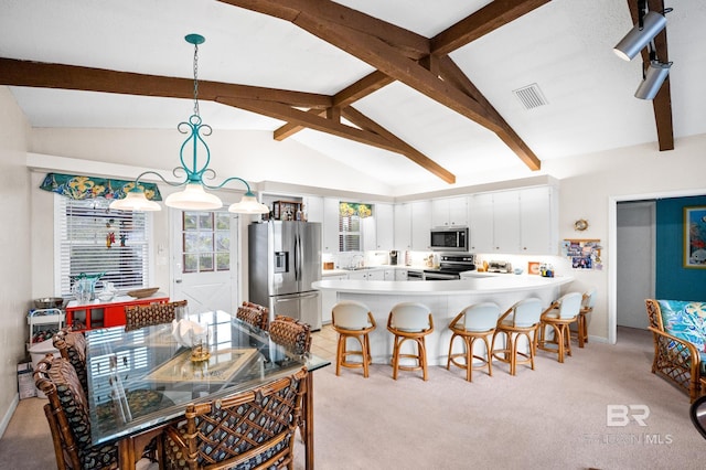 dining area featuring light carpet, visible vents, and lofted ceiling with beams