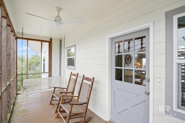 sunroom / solarium with a ceiling fan