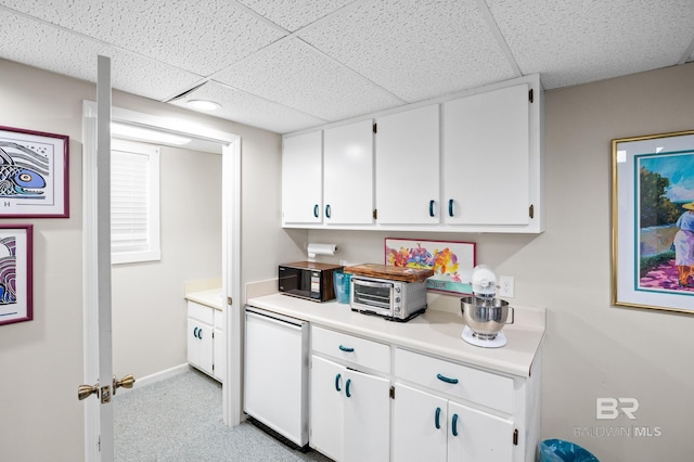 bar featuring black microwave, a paneled ceiling, light colored carpet, refrigerator, and baseboards