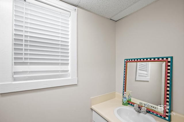 bathroom featuring a drop ceiling and vanity