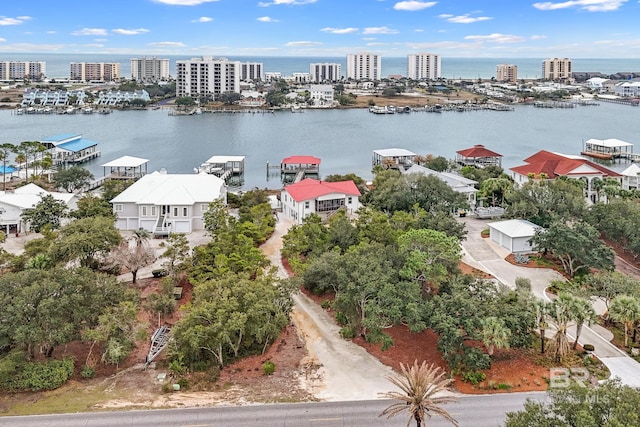 birds eye view of property with a view of city and a water view