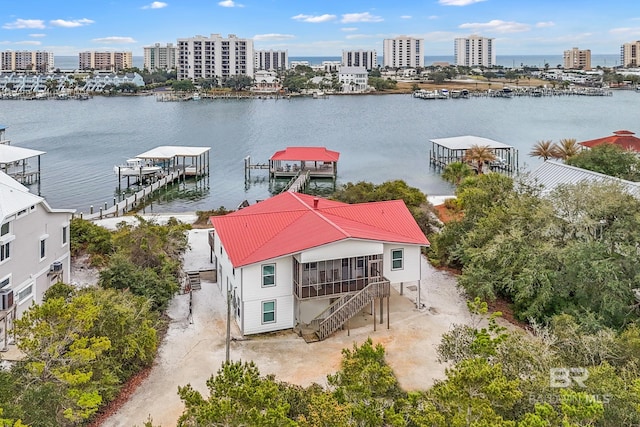 birds eye view of property featuring a view of city and a water view