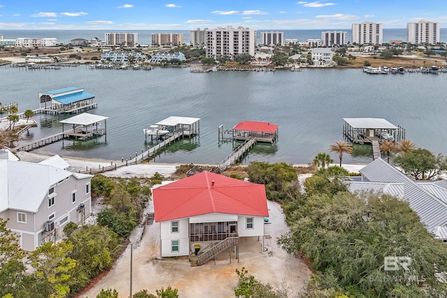 drone / aerial view featuring a view of city and a water view