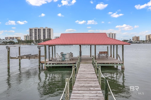 dock area with a water view, boat lift, and a city view