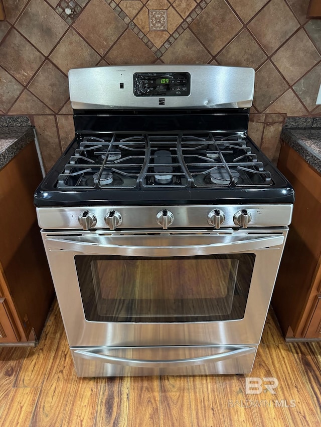 253 Cherokee St, Mobile, AL 36606 - kitchen view of stainless steel gas range, dark countertops, decorative backsplash, and tile walls