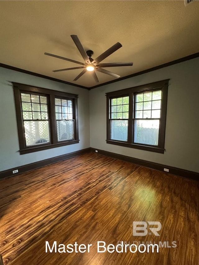 253 Cherokee St, Mobile, AL 36606 - spare room featuring ornamental molding, dark wood finished floors, a ceiling fan, baseboards, and healthy amount of natural light