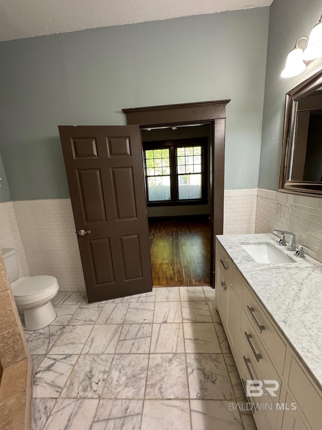 253 Cherokee St, Mobile, AL 36606 - bathroom featuring toilet, vanity, and a wainscoted wall