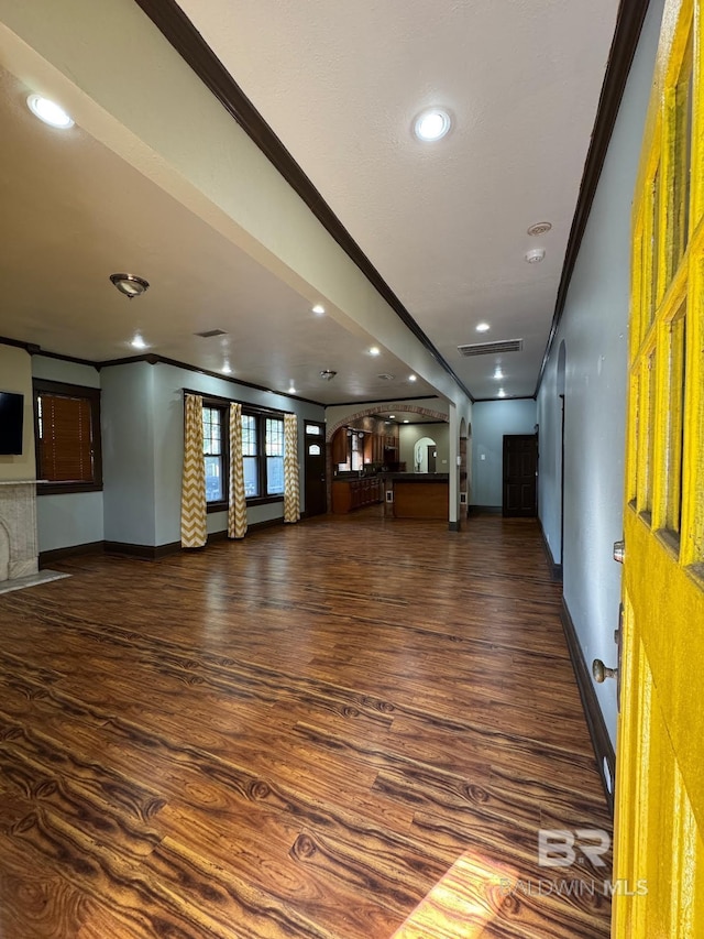 253 Cherokee St, Mobile, AL 36606 - unfurnished living room featuring crown molding, baseboards, wood finished floors, arched walkways, and recessed lighting