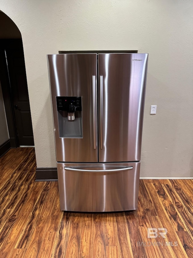 253 Cherokee St, Mobile, AL 36606 - kitchen view of stainless steel fridge with ice dispenser, arched walkways, dark wood finished floors, and baseboards