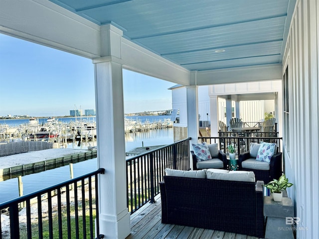 balcony featuring a water view and outdoor lounge area