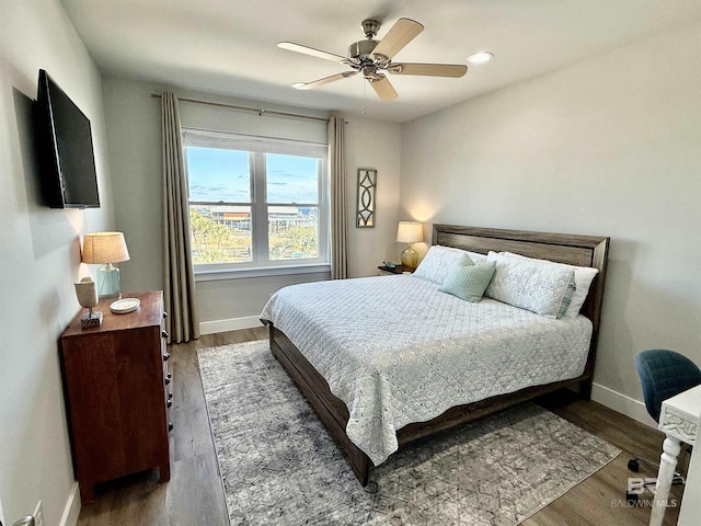 bedroom with dark wood-type flooring and ceiling fan