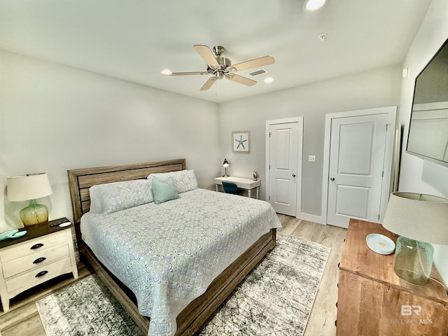 bedroom with ceiling fan and light hardwood / wood-style floors