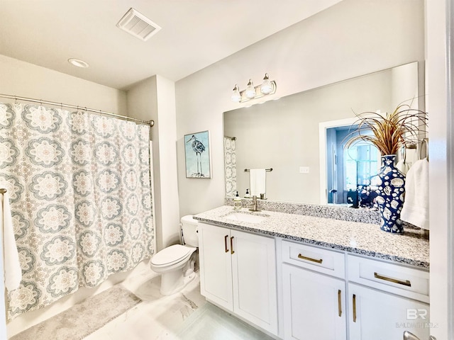 bathroom featuring vanity and toilet