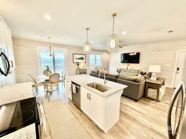 kitchen with white cabinetry, sink, electric range, and decorative light fixtures