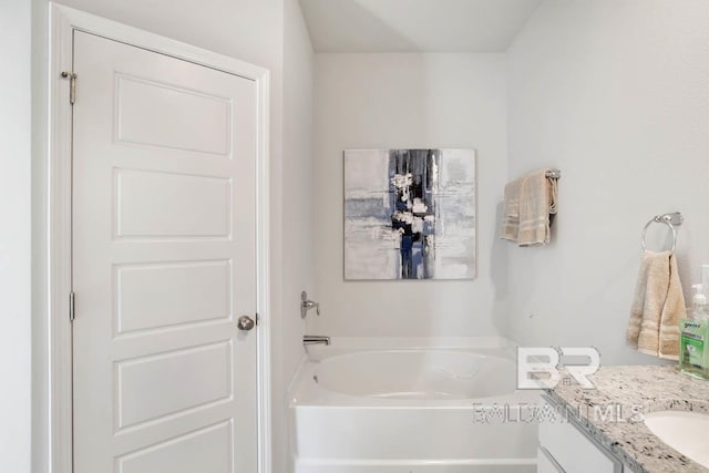 full bathroom with a garden tub and vanity