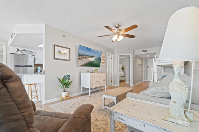 26802 Perdido Beach Blvd Unit 7C2, Orange Beach, AL 36561 - living room featuring baseboards, ceiling fan, visible vents, and light tile patterned floors