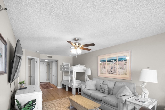 26802 Perdido Beach Blvd Unit 7C2, Orange Beach, AL 36561 - living room featuring light tile patterned floors, ceiling fan, a textured ceiling, and visible vents
