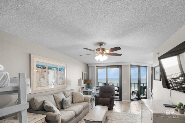 26802 Perdido Beach Blvd Unit 7C2, Orange Beach, AL 36561 - living room featuring a textured ceiling, ceiling fan, and light tile patterned floors