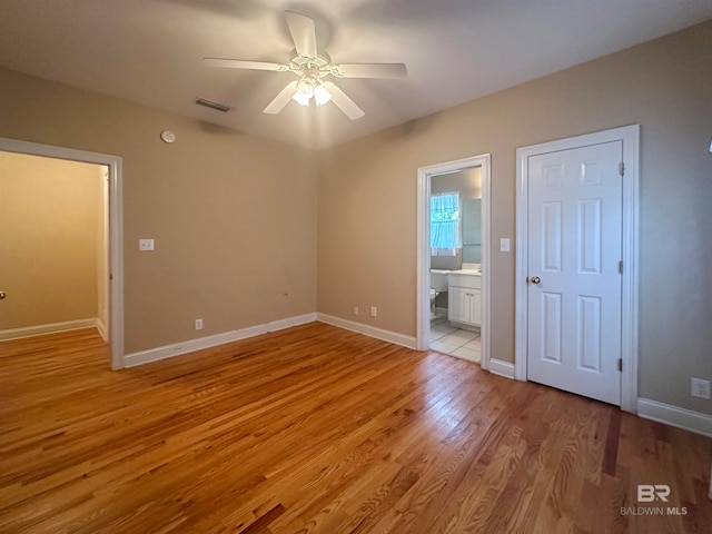 empty room with ceiling fan and wood-type flooring