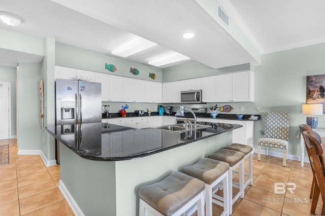 26200 Perdido Beach Blvd Unit 508, Orange Beach, AL 36561 - kitchen with light tile patterned floors, white cabinetry, appliances with stainless steel finishes, a sink, and baseboards