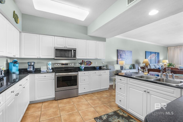 26200 Perdido Beach Blvd Unit 508, Orange Beach, AL 36561 - kitchen featuring open floor plan, dark countertops, visible vents, appliances with stainless steel finishes, and a sink