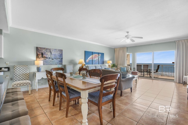 tiled dining room with ornamental molding, a water view, and ceiling fan