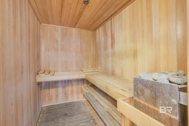 view of sauna with wood walls, wooden ceiling, and hardwood / wood-style flooring