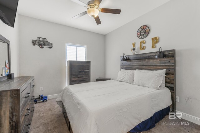 carpeted bedroom with baseboards and ceiling fan