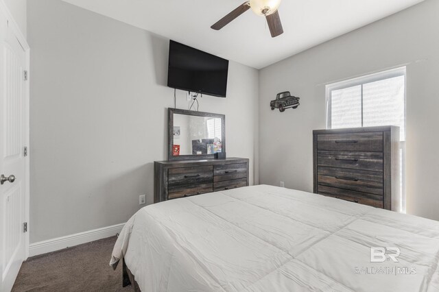 carpeted bedroom featuring baseboards and ceiling fan