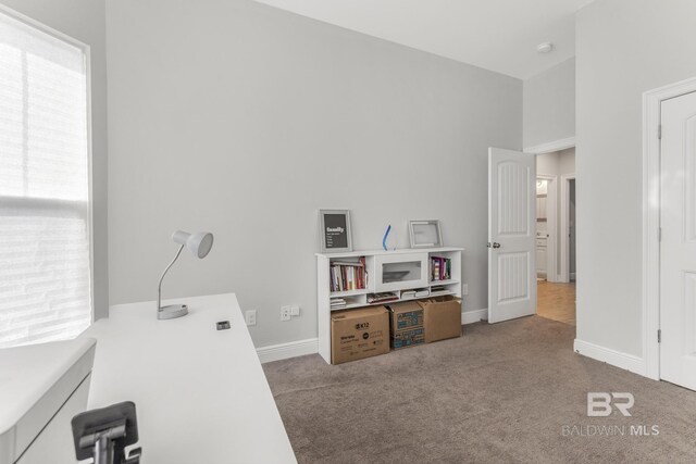 carpeted home office with baseboards