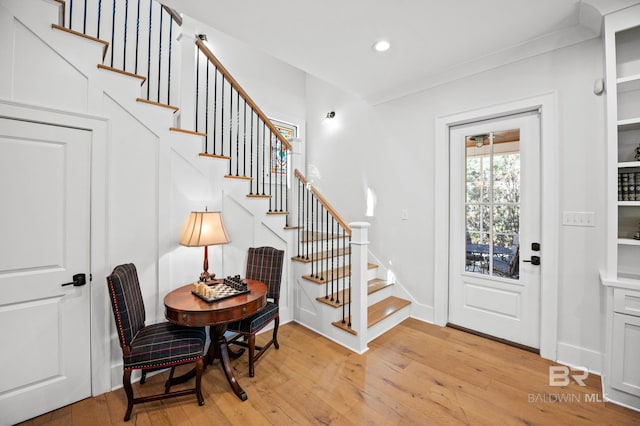 entrance foyer with baseboards, light wood finished floors, stairway, and recessed lighting