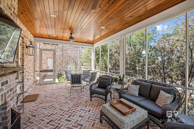 sunroom with a fireplace and wood ceiling