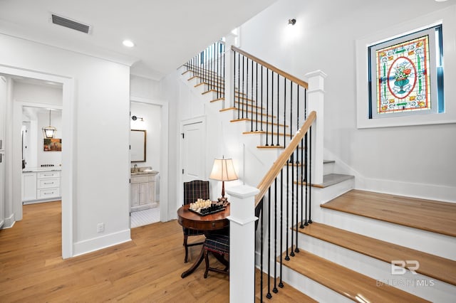 stairs with baseboards, visible vents, wood finished floors, and recessed lighting