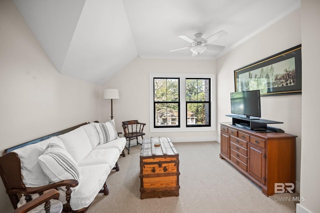 living room with lofted ceiling, ceiling fan, and light colored carpet