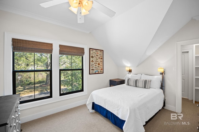 carpeted bedroom featuring ceiling fan, baseboards, and vaulted ceiling