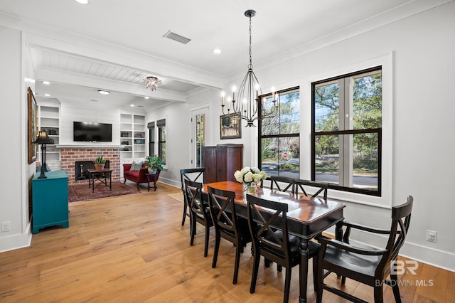 dining area featuring light wood-type flooring, beam ceiling, visible vents, and baseboards