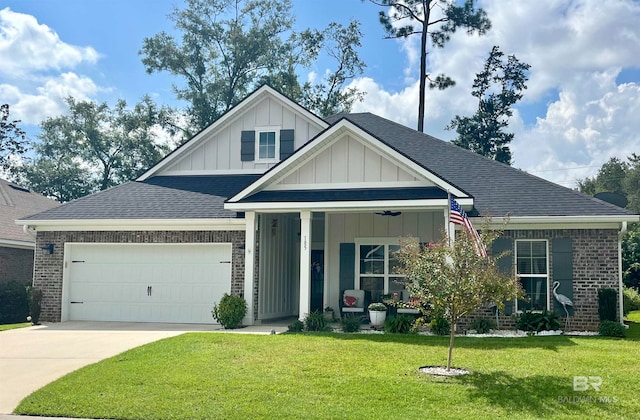 view of front of property with a garage, a front lawn, and covered porch