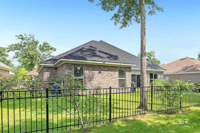 view of side of home with a lawn