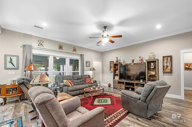 living room with ornamental molding, hardwood / wood-style floors, and ceiling fan