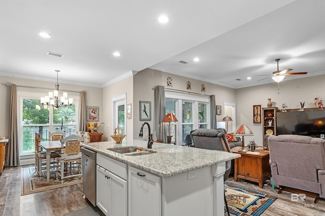 kitchen featuring an island with sink, plenty of natural light, ceiling fan with notable chandelier, and sink