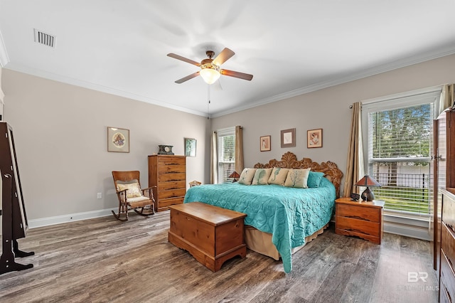 bedroom with ceiling fan, dark hardwood / wood-style floors, and crown molding