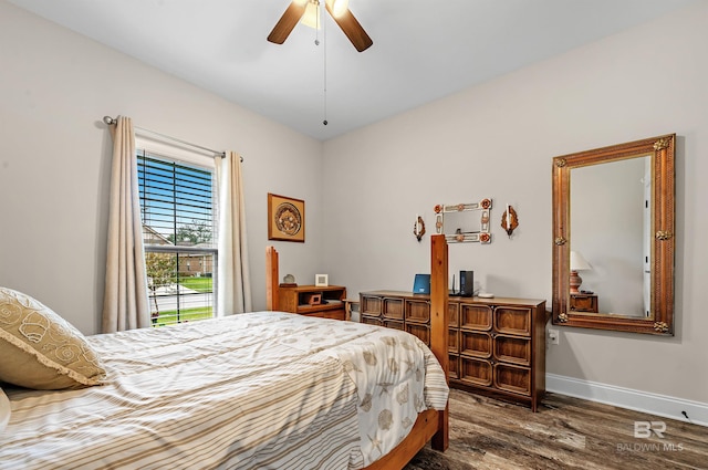 bedroom with ceiling fan and dark hardwood / wood-style flooring