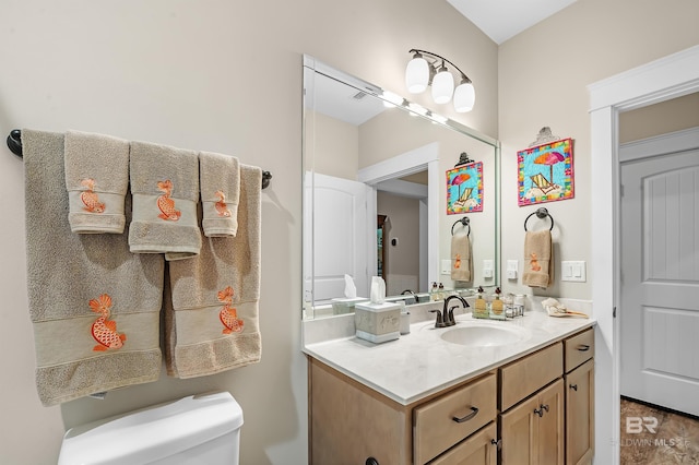 bathroom featuring vanity and toilet