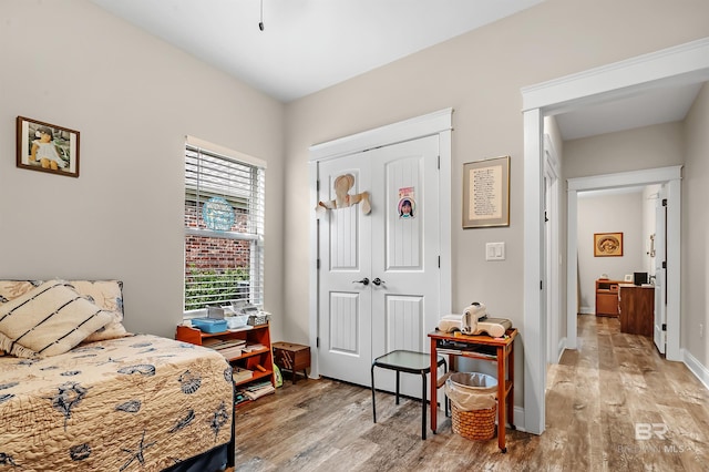 bedroom featuring a closet and light wood-type flooring