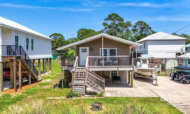 5576 Armadillo Ave, Orange Beach, AL 36561 - view of front of home with stairs, a patio, a front yard, and a deck
