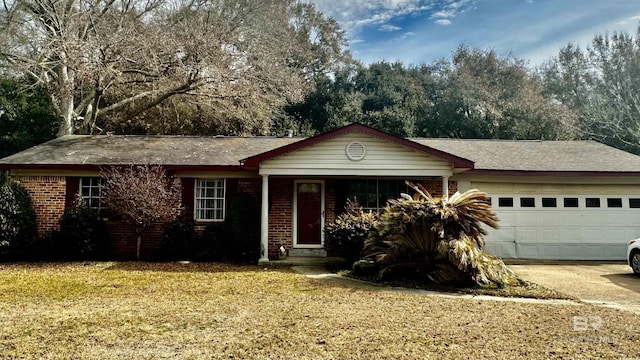 ranch-style home with a garage, driveway, brick siding, and a front lawn