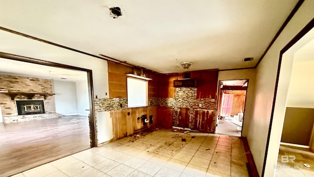 interior space featuring crown molding, a fireplace, and backsplash