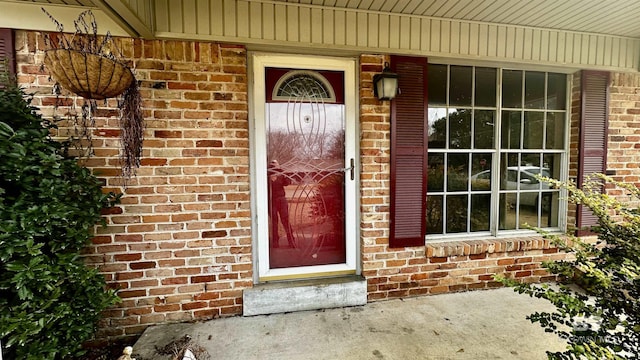 property entrance featuring brick siding