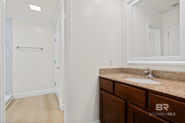 4310 Lauder Ln, Orange Beach, AL 36561 - full bathroom featuring visible vents, crown molding, baseboards, wood finished floors, and vanity
