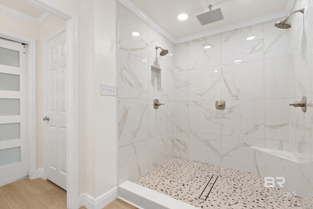 4310 Lauder Ln, Orange Beach, AL 36561 - full bath with baseboards, wood finished floors, crown molding, and tiled shower